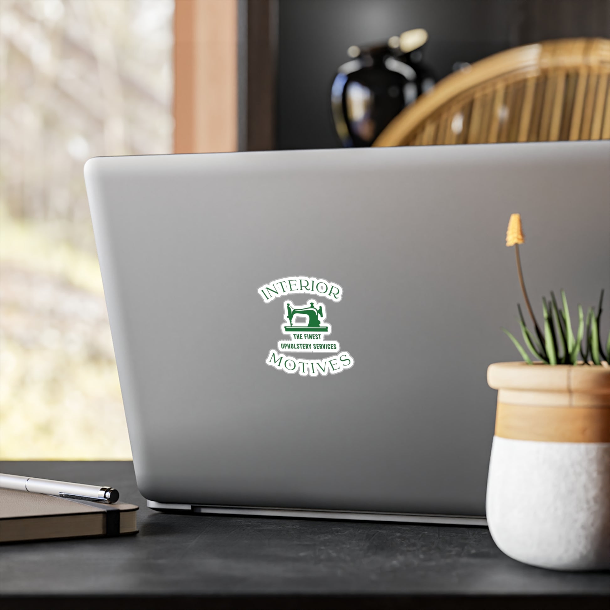 Interior Motives Logo Kiss-Cut Vinyl Decal on Laptop
